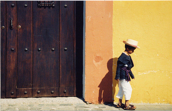 boy at yellow wall